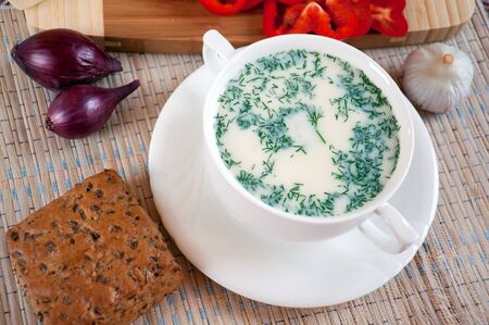 Cheese soup with dill and cereal breadの写真素材