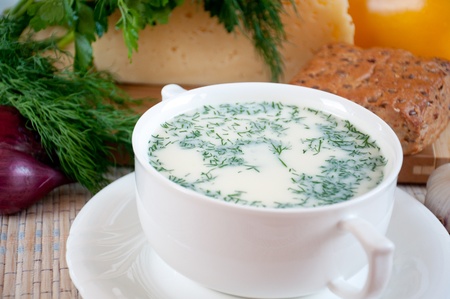 Cheese soup with dill and cereal breadの写真素材