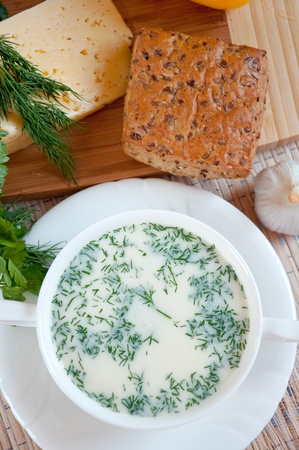 Cheese soup with dill and cereal breadの写真素材
