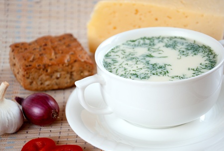Cheese soup with dill and cereal breadの写真素材