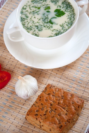 Cheese soup with dill and cereal breadの写真素材