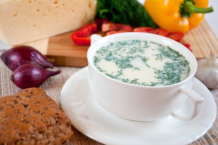 Cheese soup with dill and cereal breadの写真素材