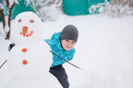 A boy and a snowman - a winter holidayの写真素材