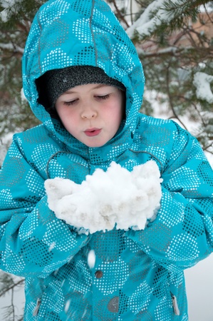 The Boy in the snowy winter parkの写真素材