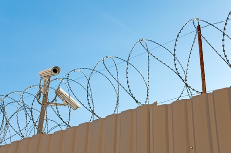 Camera surveillance and barbed wireの写真素材