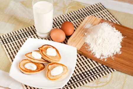Home pancakes with sour cream, flour and eggsの写真素材
