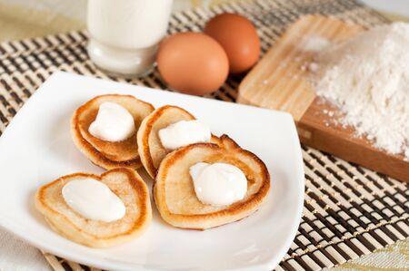 Home pancakes with sour cream, flour and eggsの写真素材