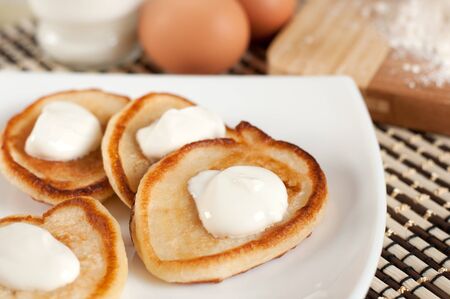 Home pancakes with sour cream, flour and eggsの写真素材