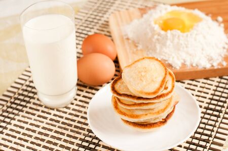 Home pancakes with sour cream, flour and eggsの写真素材