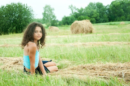 Beautiful long-haired girl in a fieldの写真素材