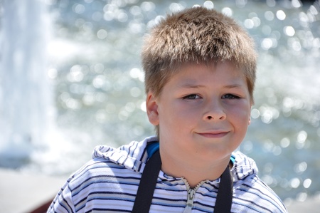 Portrait of a boy on the background of the fountainの写真素材