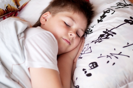 The boy was asleep on a pillow with Chinese charactersの写真素材