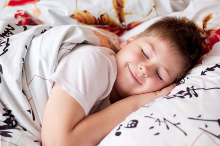 The boy was asleep on a pillow with Chinese charactersの写真素材