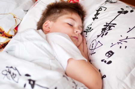 The boy was asleep on a pillow with Chinese charactersの写真素材