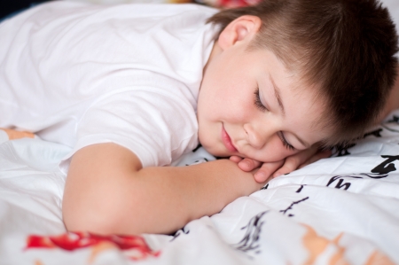 The boy was asleep on a pillow with Chinese charactersの写真素材