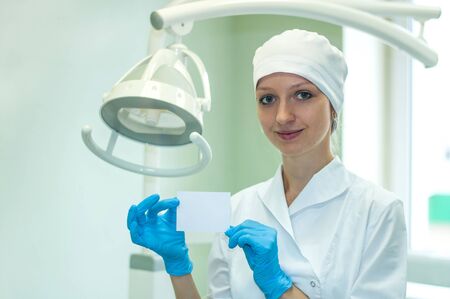 Female doctor keeps a card in his handの写真素材