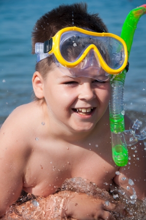 Boy at sea with a mask for snorkelingの写真素材