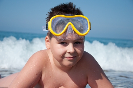 Boy at sea with a mask for snorkelingの写真素材