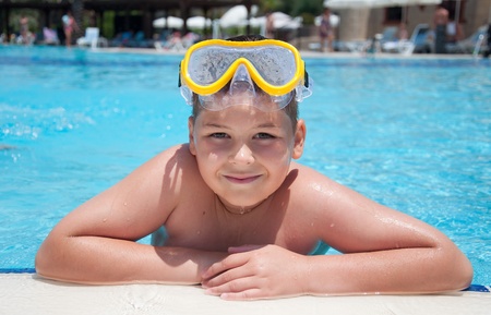 Boy with a mask for snorkeling in the poolの写真素材