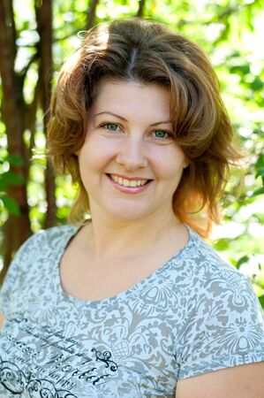 Middle-aged woman in a summer parkの写真素材