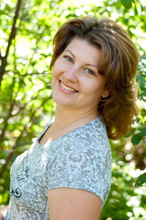 Middle-aged woman in a summer parkの写真素材