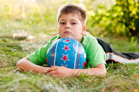 The boy with the ball on the natureの写真素材