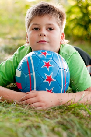 The boy with the ball on the natureの写真素材