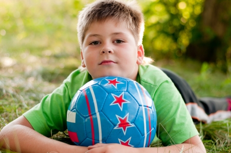The boy with the ball on the natureの写真素材