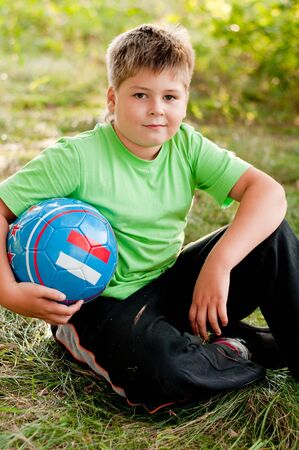 The boy with the ball on the natureの写真素材