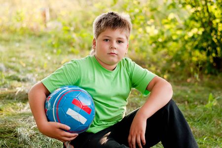 The boy with the ball on the natureの写真素材