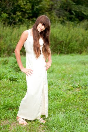 Teenage girl in a white dress on the natureの写真素材