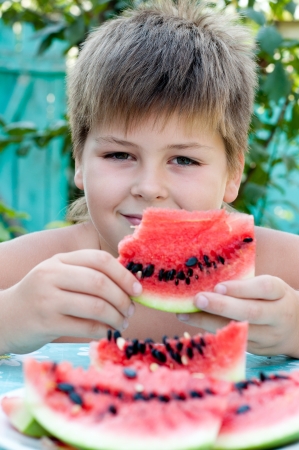 Boy eating a ripe watermelonの写真素材