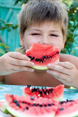Boy eating a ripe watermelonの写真素材