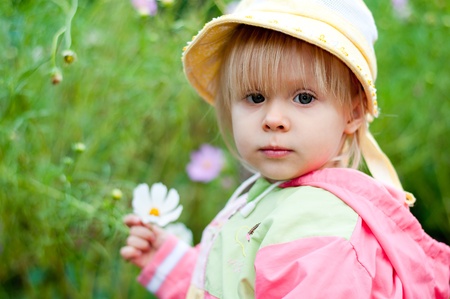 Little girl with flowers 2.5 yearsの写真素材