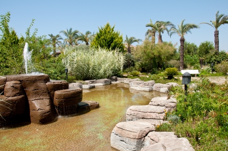 Landscaping - a stone fountain and pondの写真素材