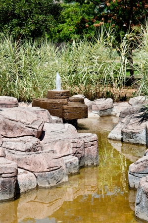 Landscaping - a stone fountain and pondの写真素材