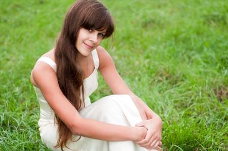 Teenage girl in a white dress on the natureの写真素材