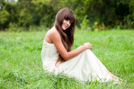 Teenage girl in a white dress on the natureの写真素材