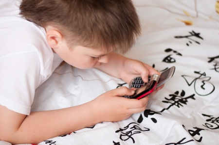 Boy playing on cell phonesの写真素材
