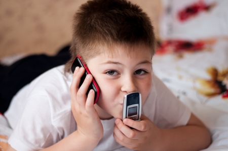 Boy playing on cell phonesの写真素材