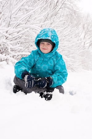 Boy in a snowy forestの写真素材