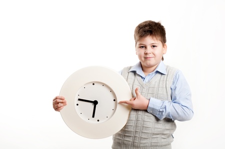 boy with a clock on a light backgroundの写真素材