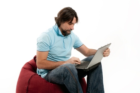 A man with a laptop on a light backgroundの写真素材