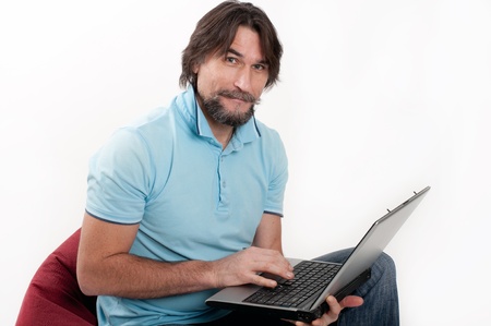 A man with a laptop on a light backgroundの写真素材