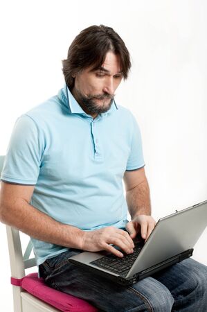 A man with a laptop on a light backgroundの写真素材