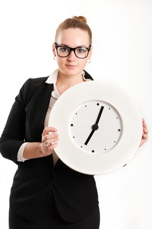 Business woman with a clock on a light backgroundの写真素材