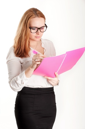 Girl with a pink folder on a light backgroundの写真素材