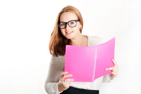 Girl with a pink folder on a light backgroundの写真素材