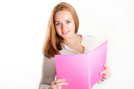 Girl with a pink folder on a light backgroundの写真素材