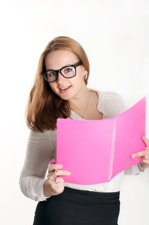 Girl with a pink folder on a light backgroundの写真素材